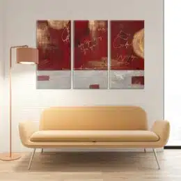 tableau triptyque abstrait rouge et gris, au dessus d'un canapé jaune clair dans un salon moderne.
