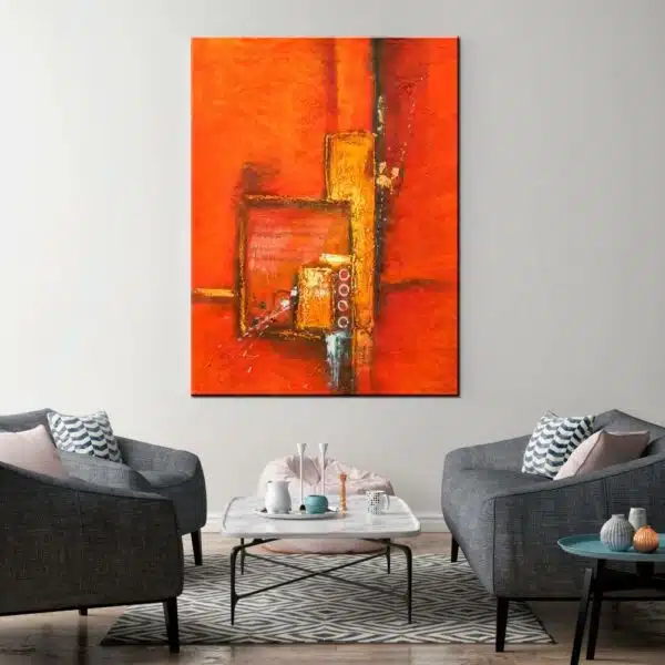 Peinture abstraite moderne orange. Bonne qualité, original, accrochée sur un mur au-dessus des chaises et d'une table basse dans une maison