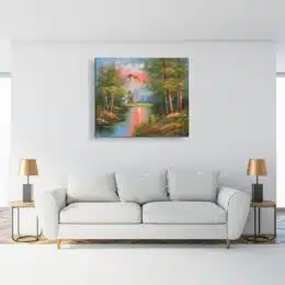 Tableau peinture montagne crépuscule accroché sur un mur avec un canapé, table basse et une veilleuse dans une maison