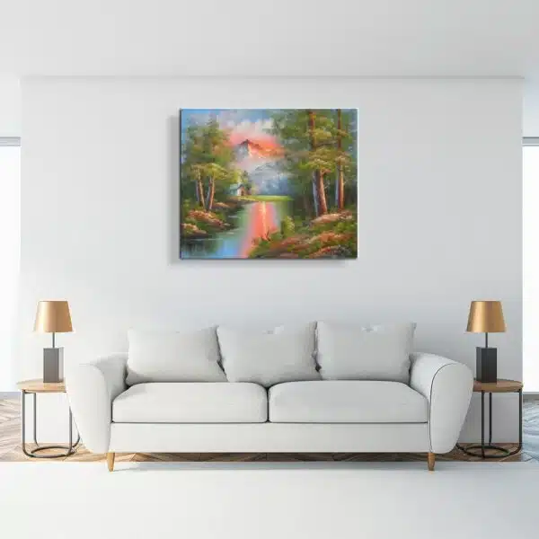 Tableau peinture montagne crépuscule accroché sur un mur avec un canapé, table basse et une veilleuse dans une maison