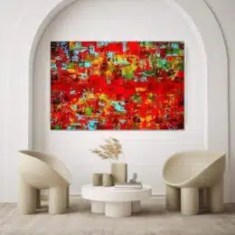 Tableau sur toile abstrait rouge accroché sur un mur dans un salon avec des chaises et une table
