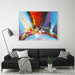 Tableau peinture abstraite bleu, accrochée sur un mur avec un canapé dans une maison