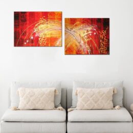 Tableau diptyque abstrait jaune orange. Accroché sur un mur avec un canapé dans une maison