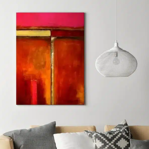 Tableau abstrait orange rose jaune peinture abstraite. Accrochée sur un mur avec un canapé dans une maison