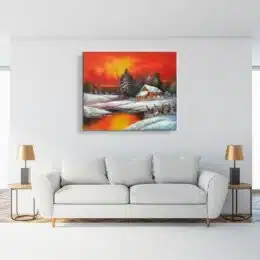 Tableau montagne vallée, coucher de soleil, accroché sur un mur avec un canapé et une veilleuse dans une maison
