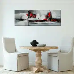 Toile panoramique gris rouge abstraite. Bonne qualité, très original, accrochée sur un mur au-dessus de deux chaises et une table dans une maison