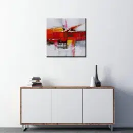 Peinture abstraite gris effets rouges, jaunes. Bonne qualité, très original accrochée sur un mur au-dessus d'une table dans un salon.