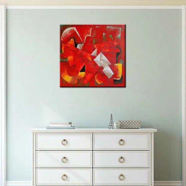Peinture toile abstraite orange et rouge carrée. Bonne qualité, très original accrochée sur un mur bleu au-dessus d'une table blanche dans un salon