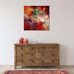 Peinture abstraite rouge bordeaux, accrochée sur un mur au-dessus d'une table dans une maison .