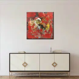 Tableau abstrait rouge noir jaune, bonne qualité, très original accrochée sur un mur au-dessus d'une table dans une maison