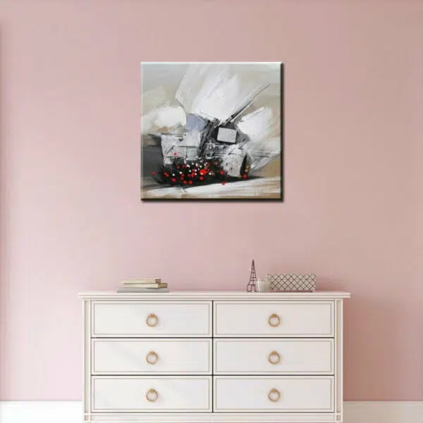 Tableau xxl abstrait beige blanc effets noirs et rouges, Bonne qualité, très original, accrochée sur un mur au-dessus d'une table blanc dans une maison.
