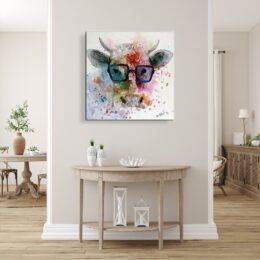 Tableau style pop art d'une vache à lunette avec des couleurs multicolore, accroché au-dessus d'une console demi-cercle en bois avec des vases sur la gauche, et des lampes en dessous